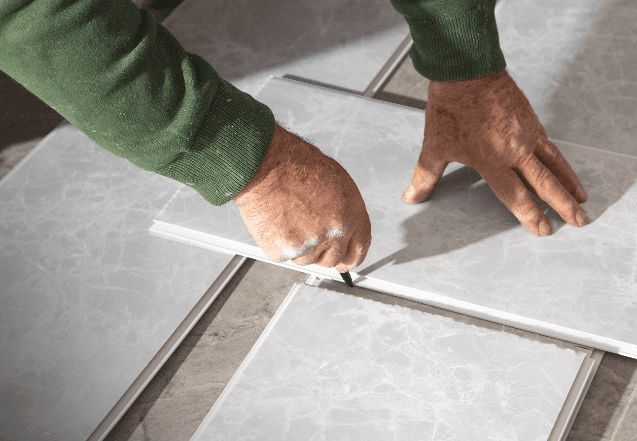 Installer setting a large-format tile with a levelling spacer